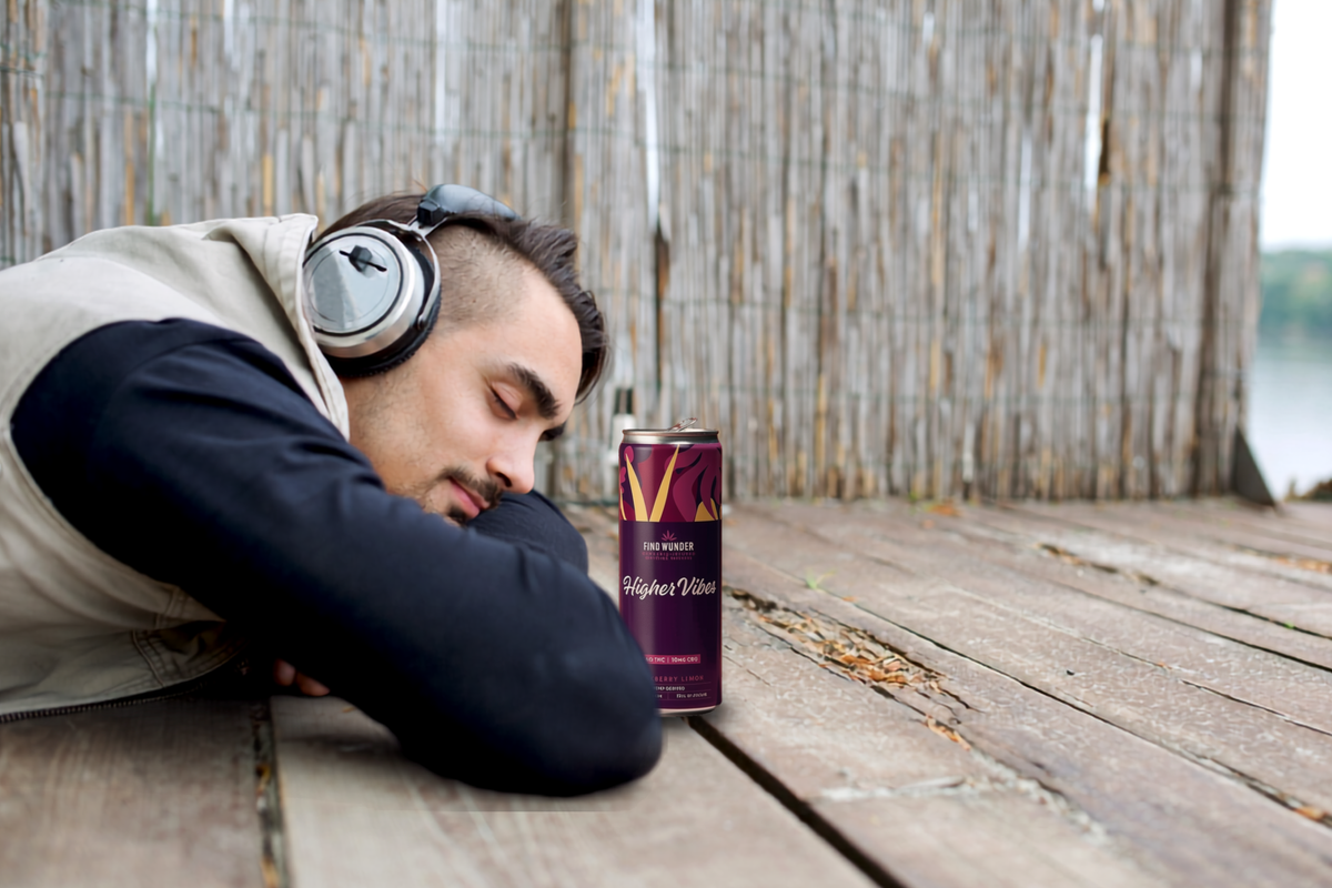man with headphones, wondering what does being high feel like, with a Find Wunder drink before him