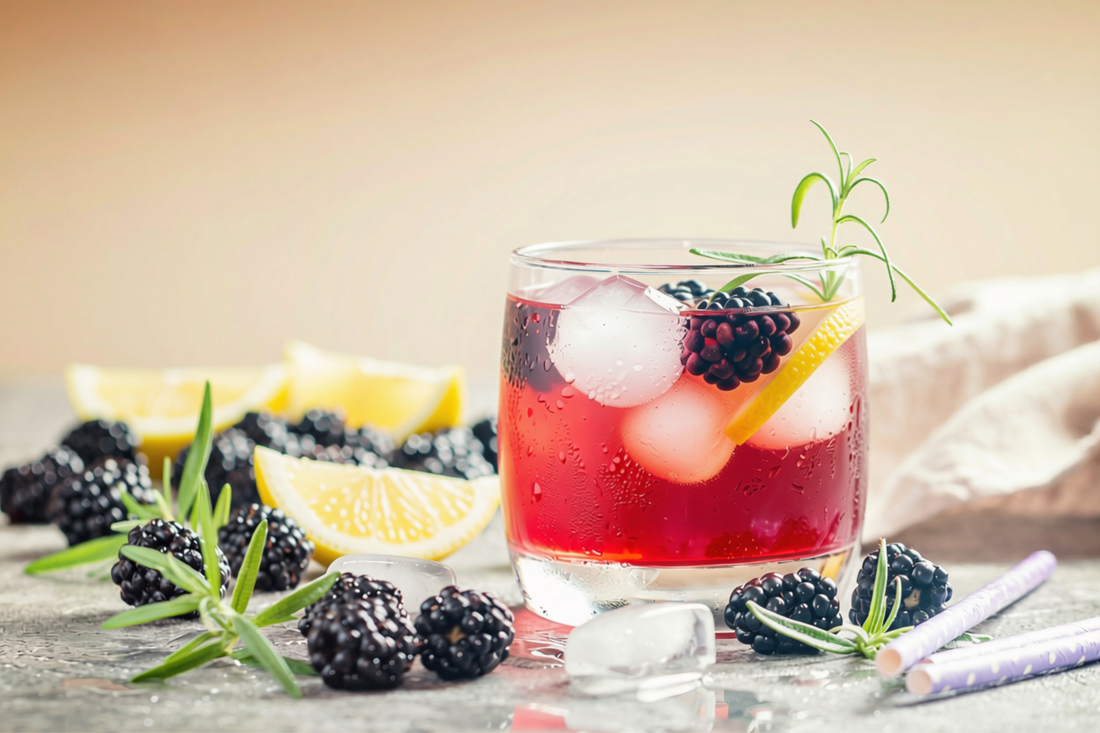 glass of Blackberry Basil Lemonade surrounded by blackberries and lemon slices