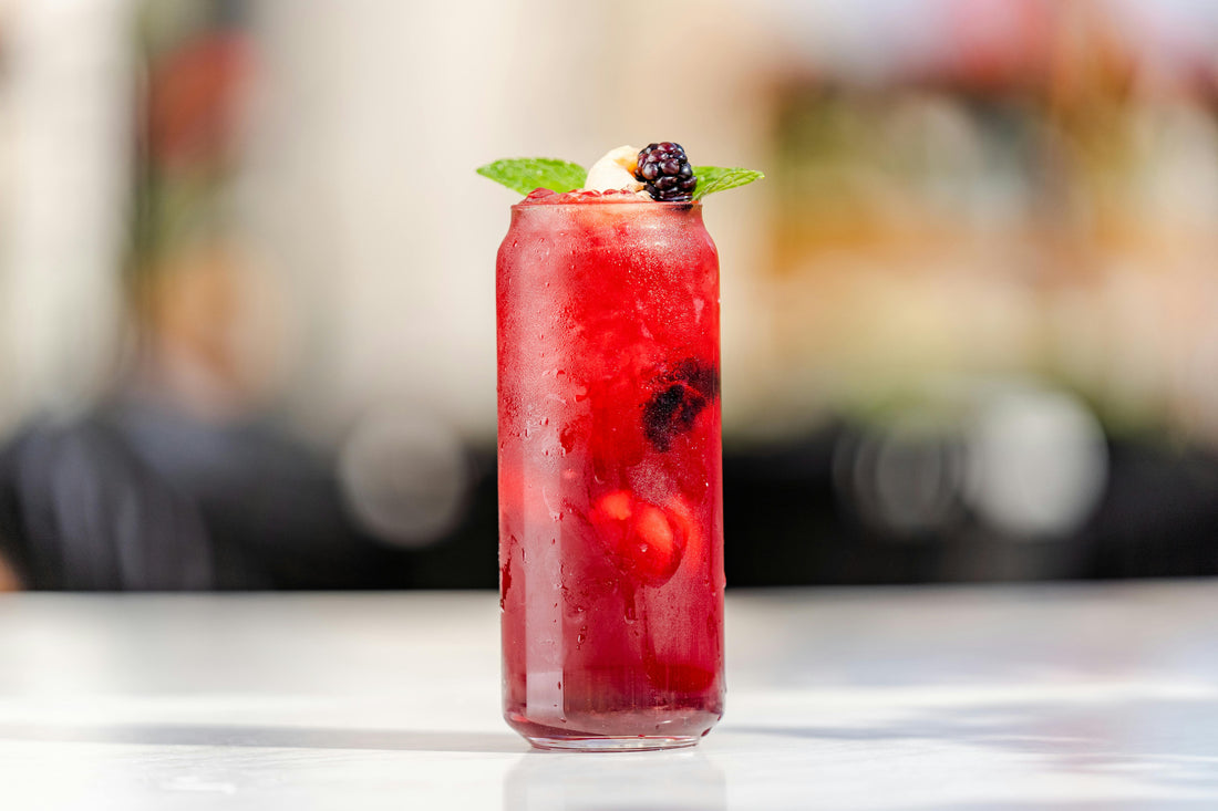 a close-up photo of a Blackberry Mint Fizz against an unfocused background